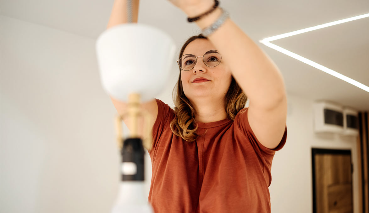 Woman-in-red-shirt-hanging-lights