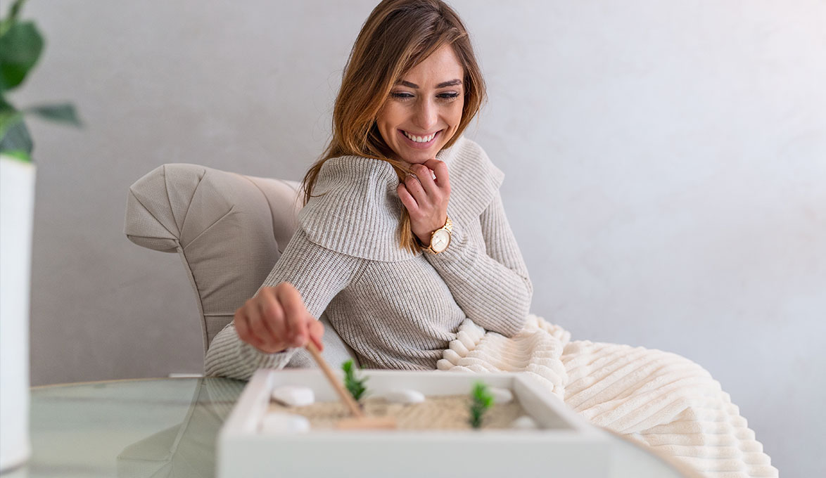 A woman using a zen garden