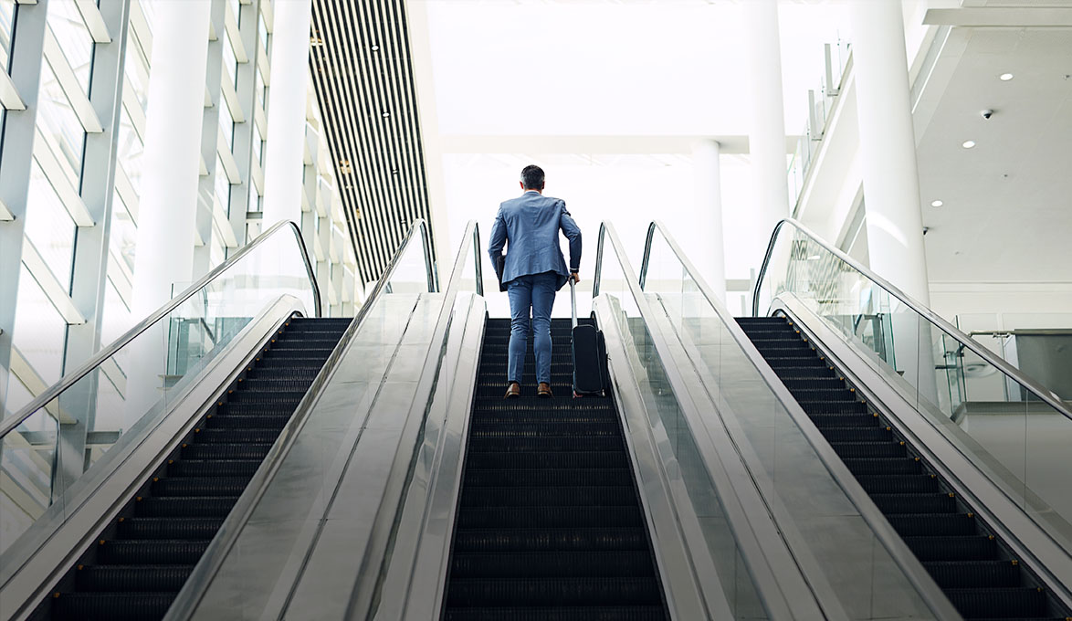 Man Climbing Escalator in Office