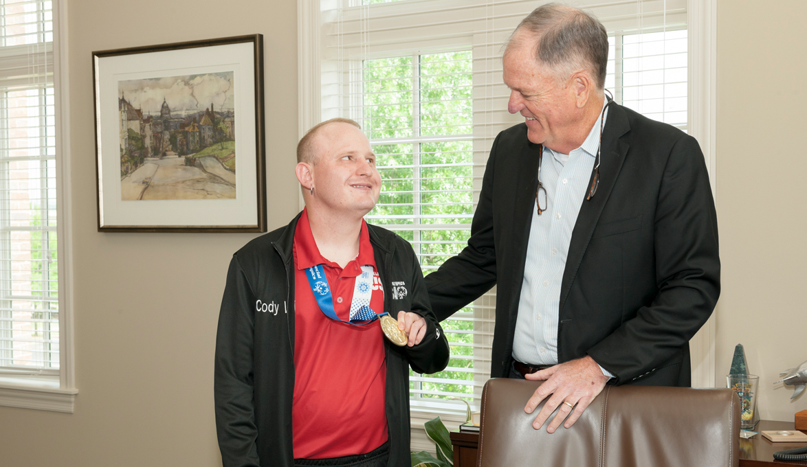 Cody Wheatley celebrating his medal at Huntsville Branch