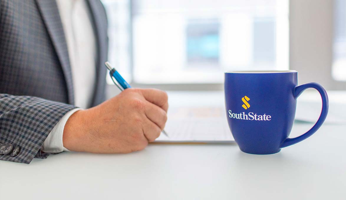 SouthState Bank employee with branded mug