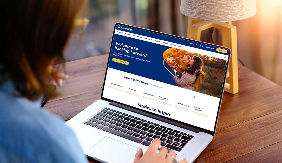Woman at desk using laptop to view SouthState Bank's New Website