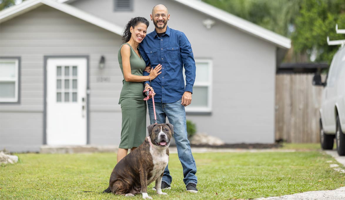 The Figueroa Family Posing for Photo with Home 