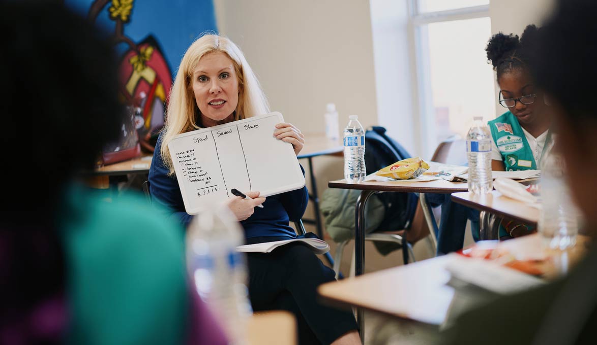 Ashley Carson reviews budgeting tips with a local Girl Scout troop