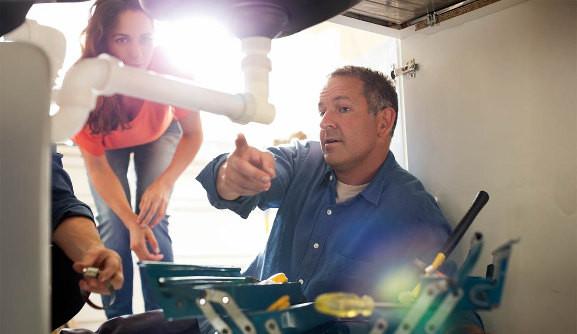 Reviewing home repair plans with licensed plumber