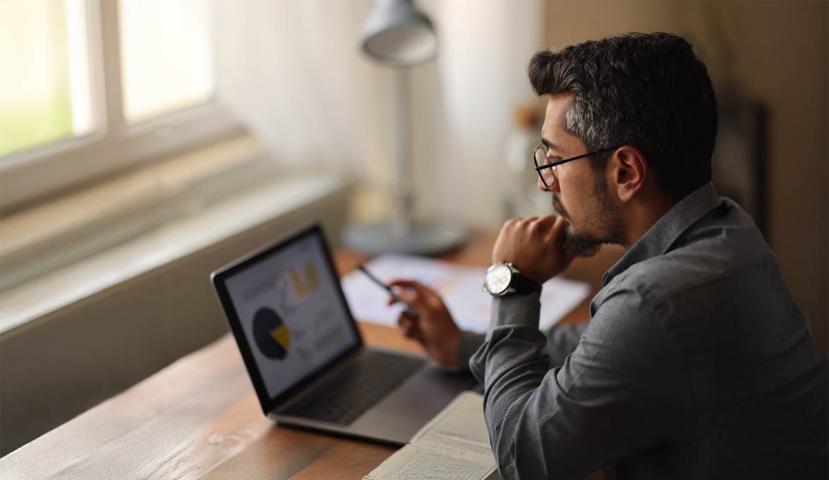 Gentleman sitting at table learning investing techniques