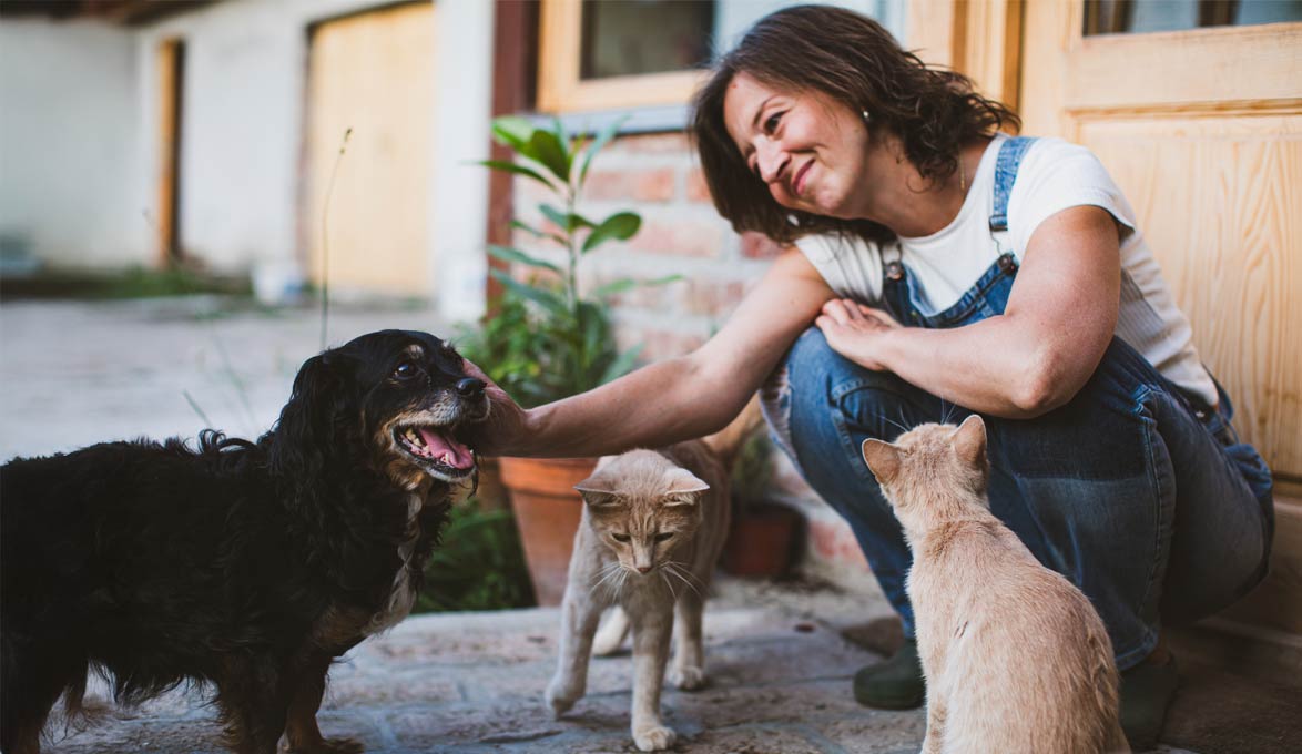 Woman with animals on front porch