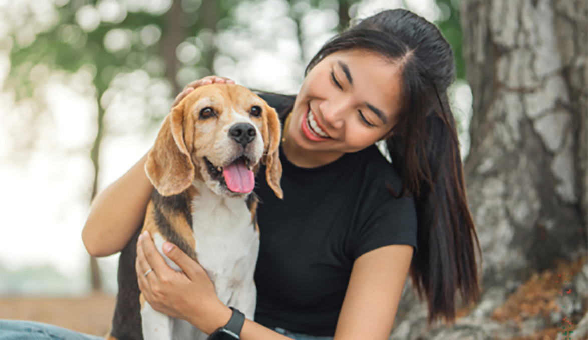 a woman petting her dog