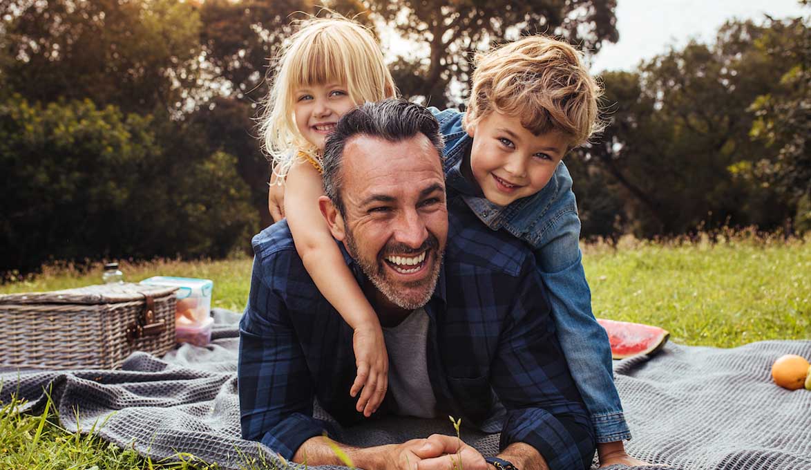 A man and his children having a picnic