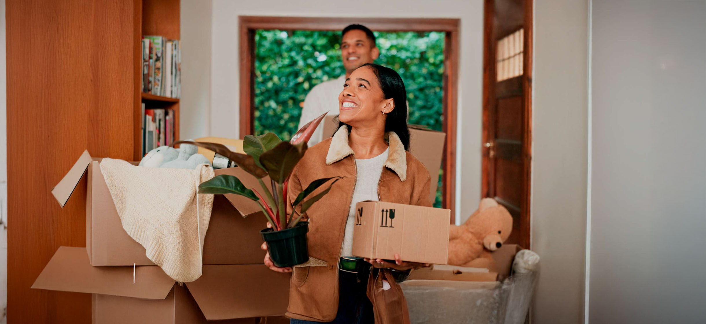 Woman moving boxes into her new home