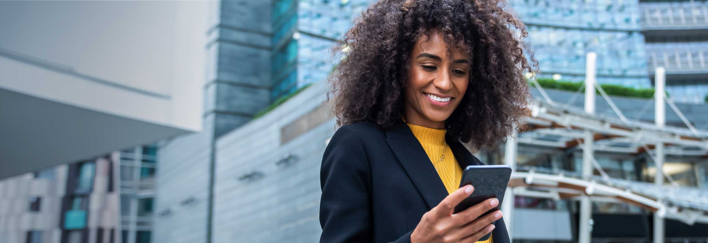 woman checking mobile phone for account alerts to protect against fraud