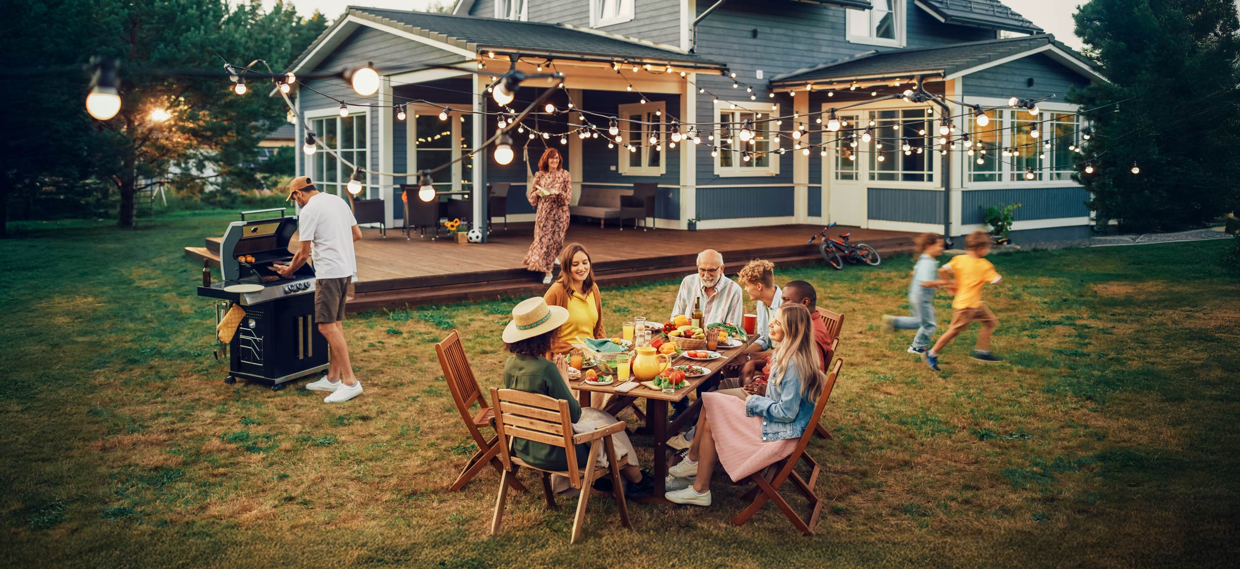 Family eating dinner outdoors in renovated backyard space