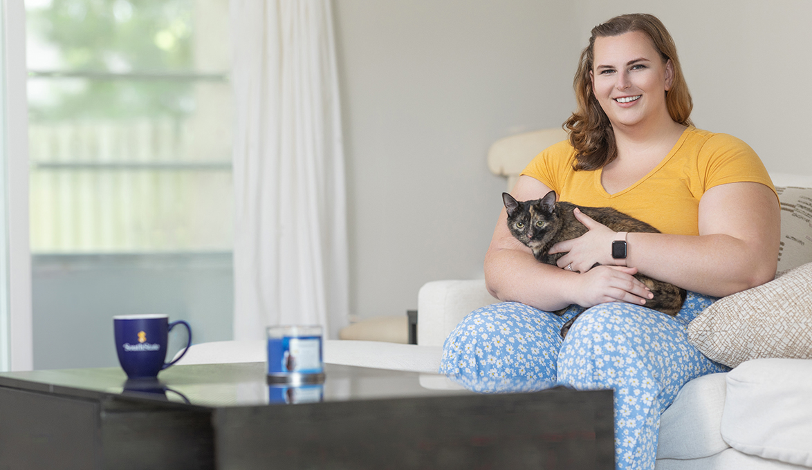 Emily Mort in new house with cat