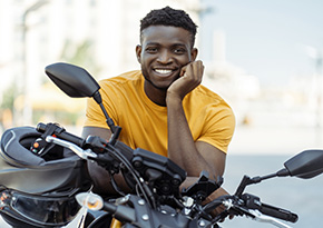 Man sitting on a parked motorcycle