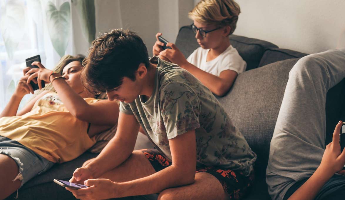 Teens sitting on the couch.