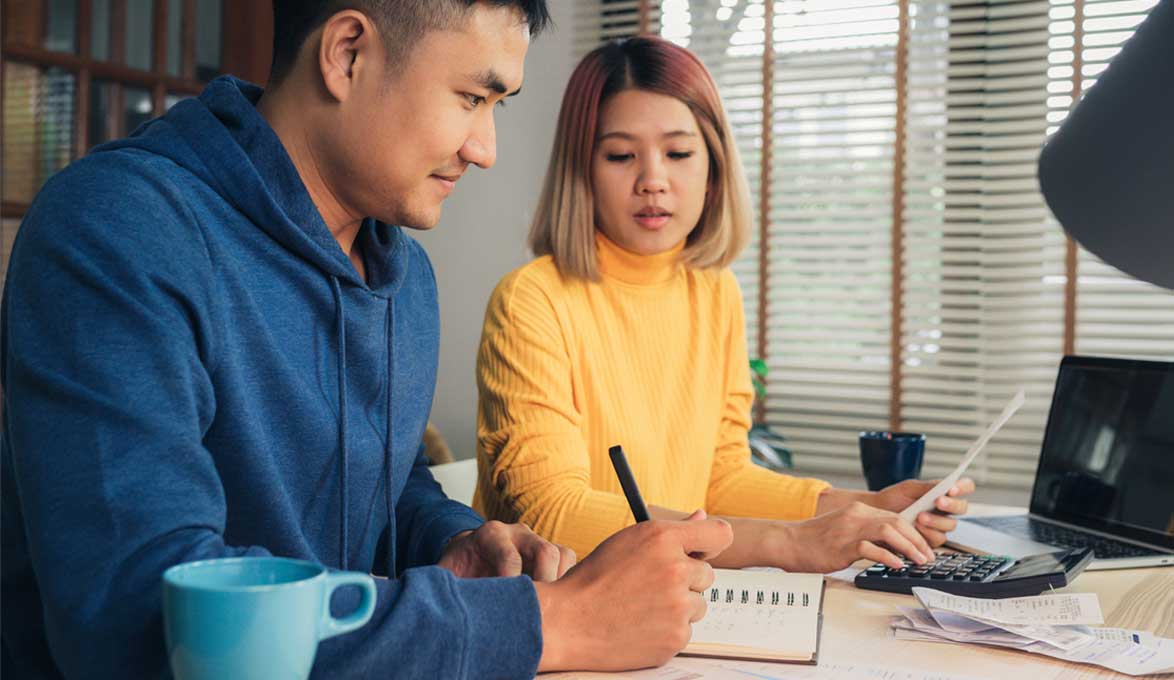 Two people learning how to manage debt