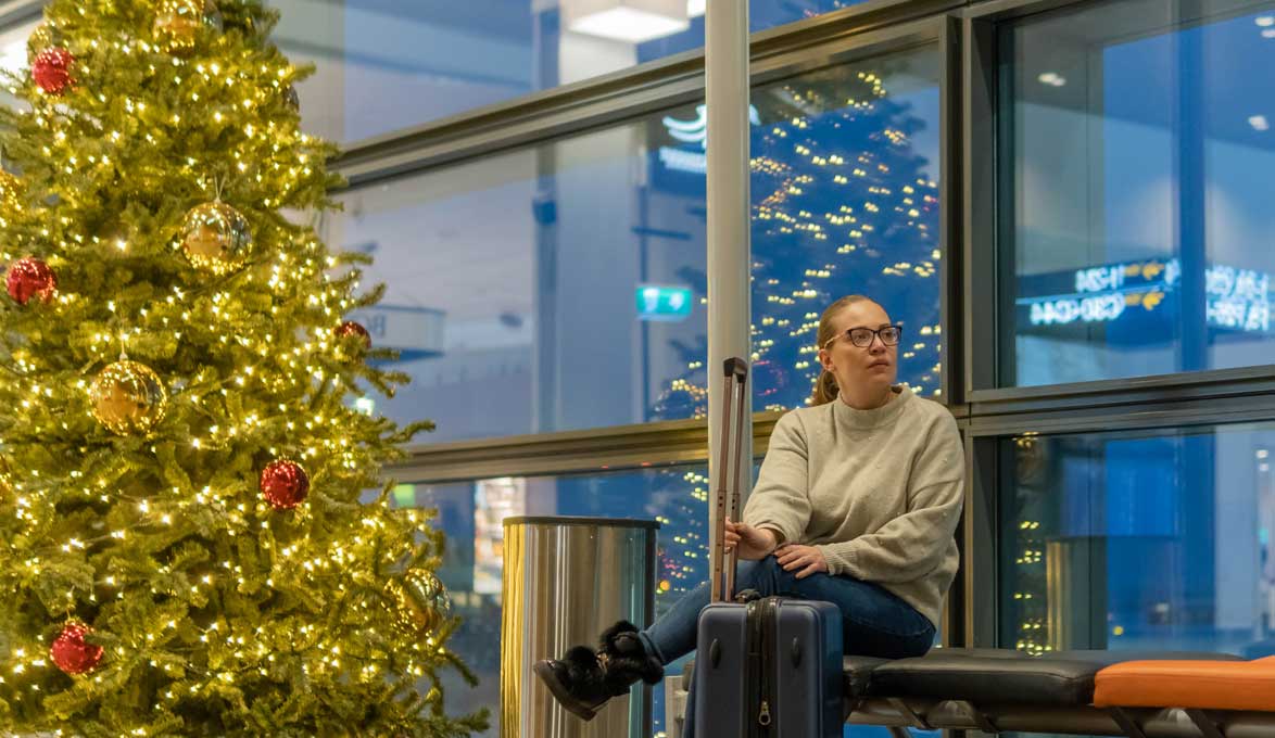 female passenger waiting for flight during the holidays