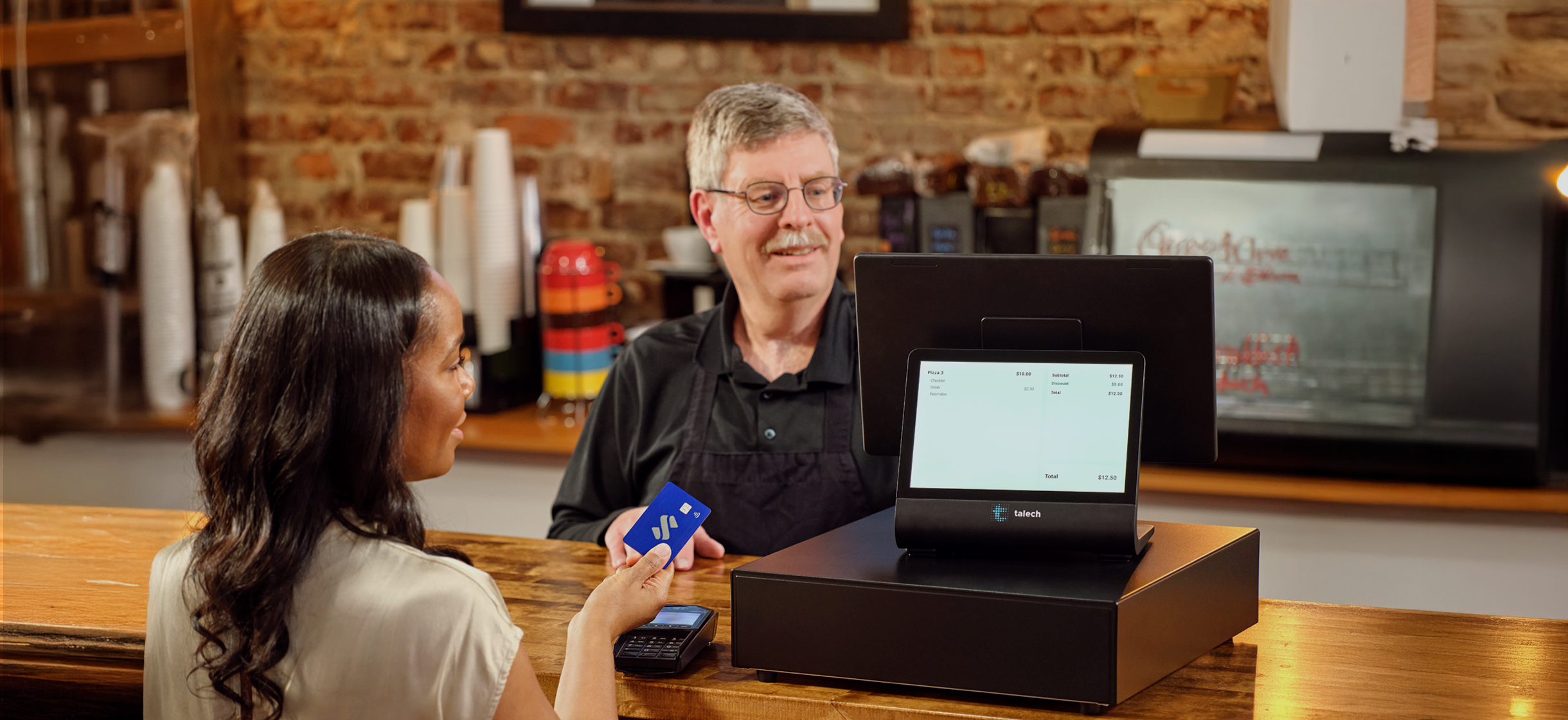 small business owner accepting payment on point of sale terminal