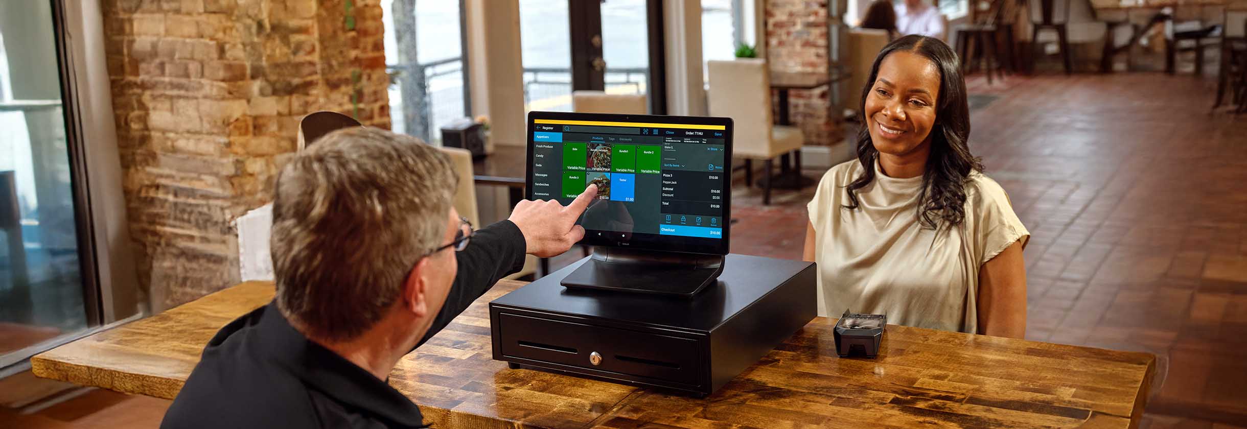 small business owner accepting payment on point of sale terminal