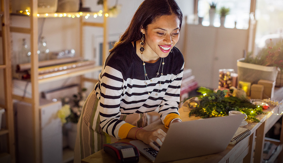 small business owner managing cash flow online during holiday season