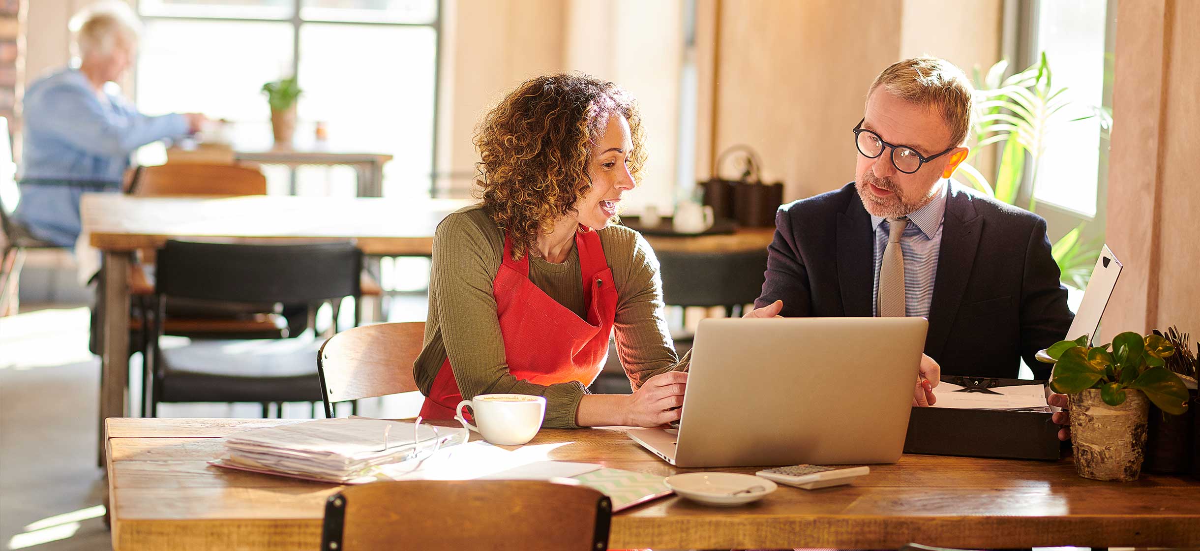 Coffee shop owner meeting with a SBA banker