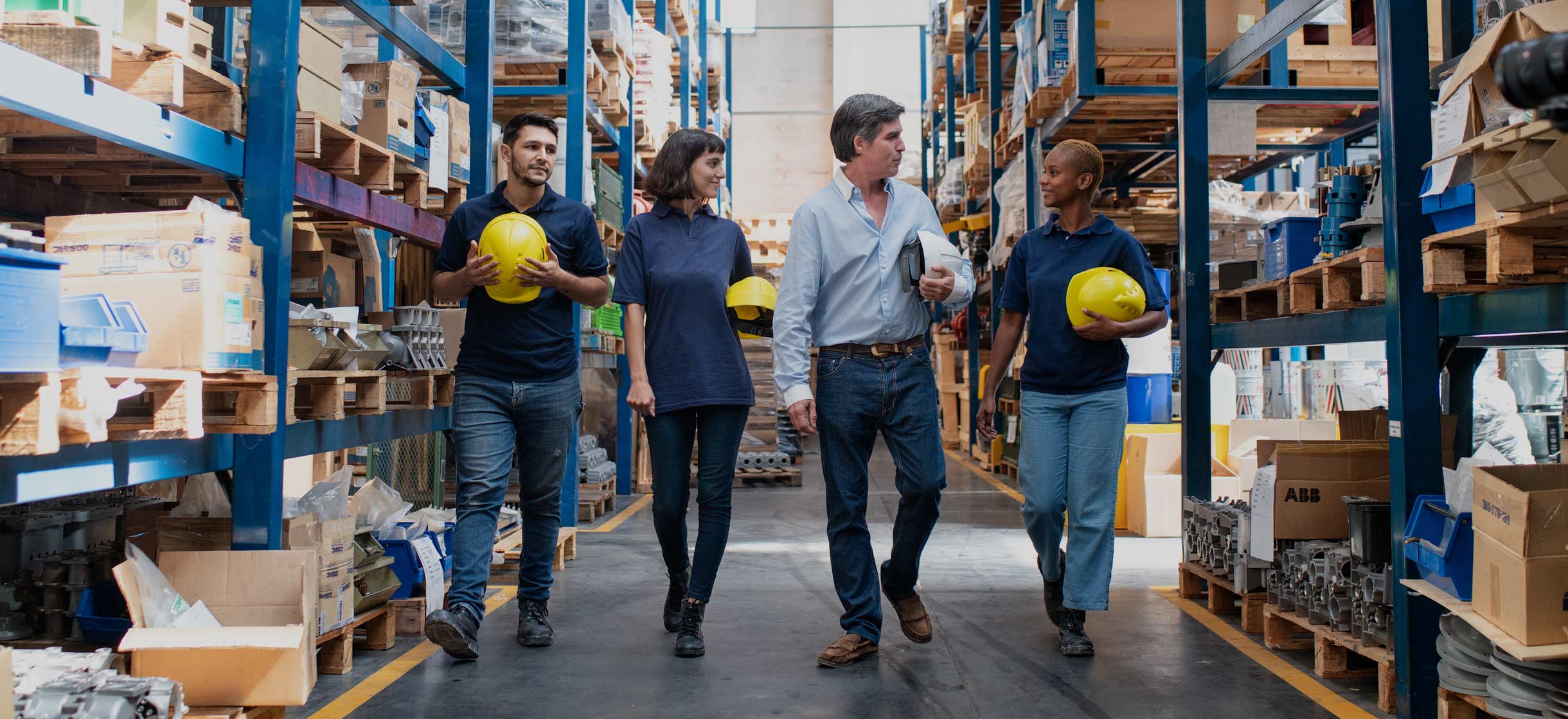 Small business owner in warehouse with employees