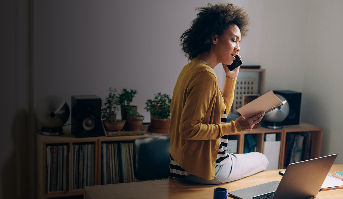 Homebased business owner talking to client on the phone.