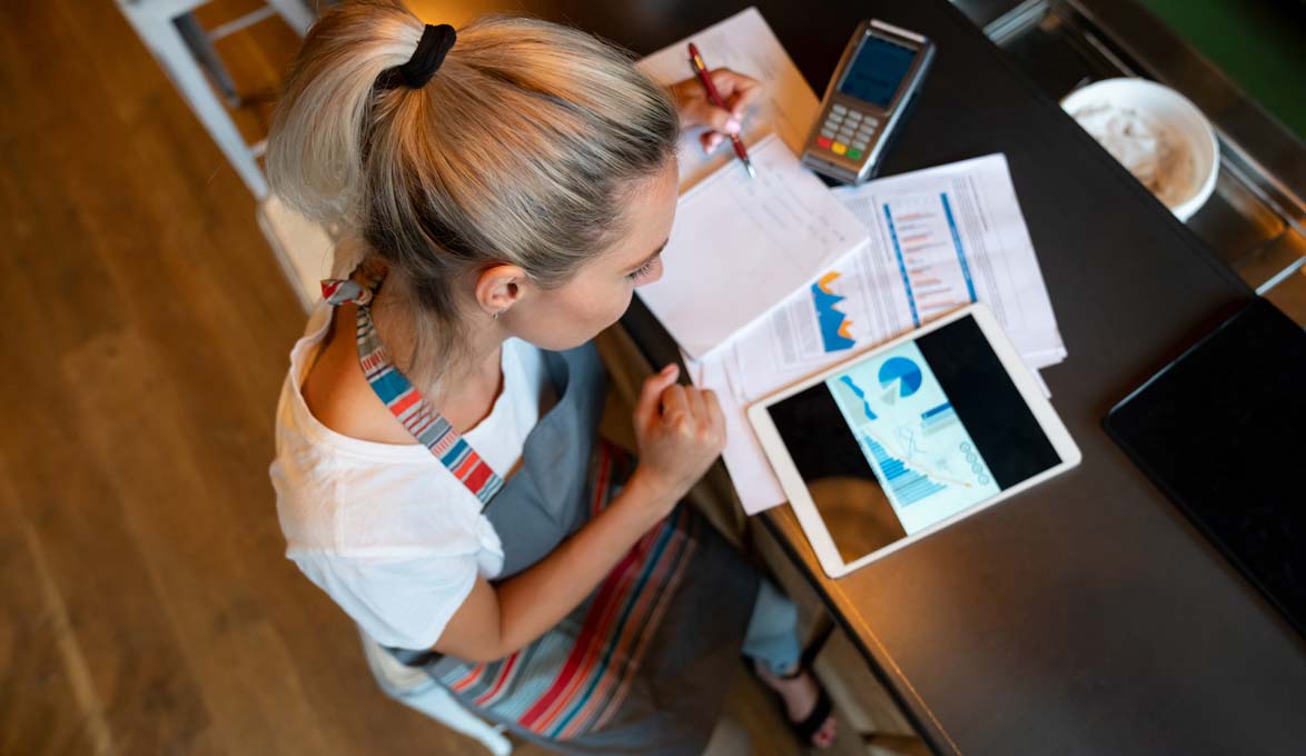woman writing a business plan to start her own business