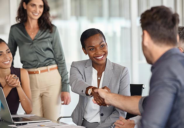 Two business people shake as they close on a loan