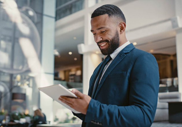 Businessman reviewing ACH transactions on a tablet
