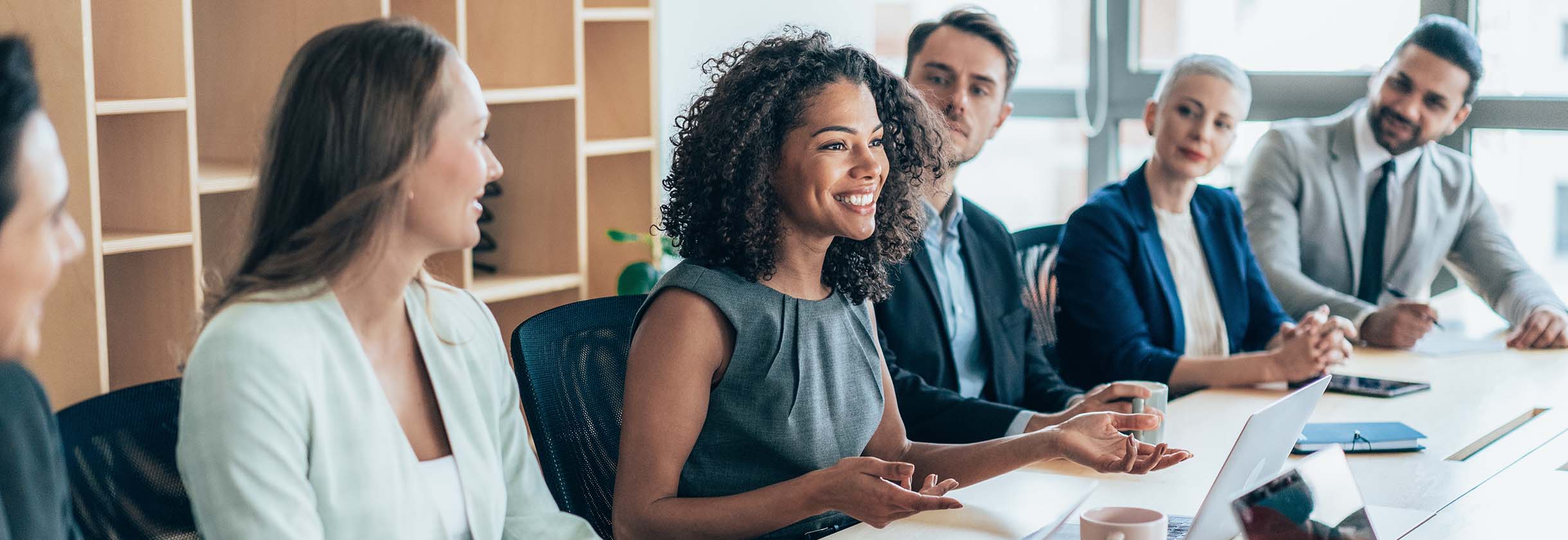 Two business people, reviewing cleared payments on a laptop