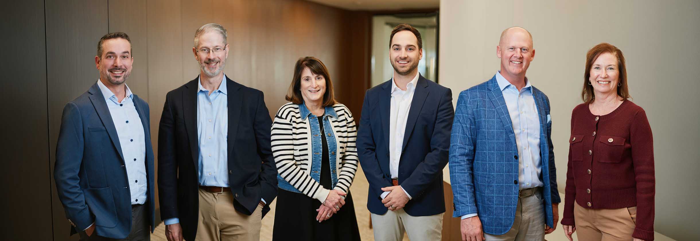 SouthState bankers stand with the people behind payday at their respective HR companies.