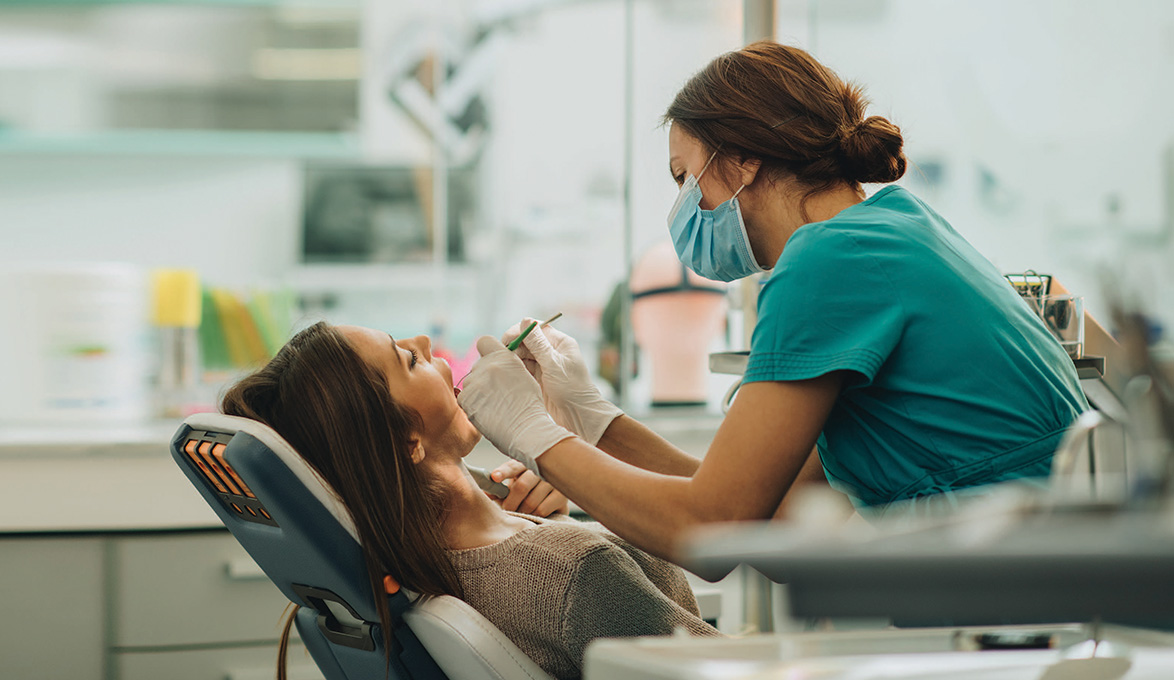 dental and medical equipment loans help a hygenist care for patient