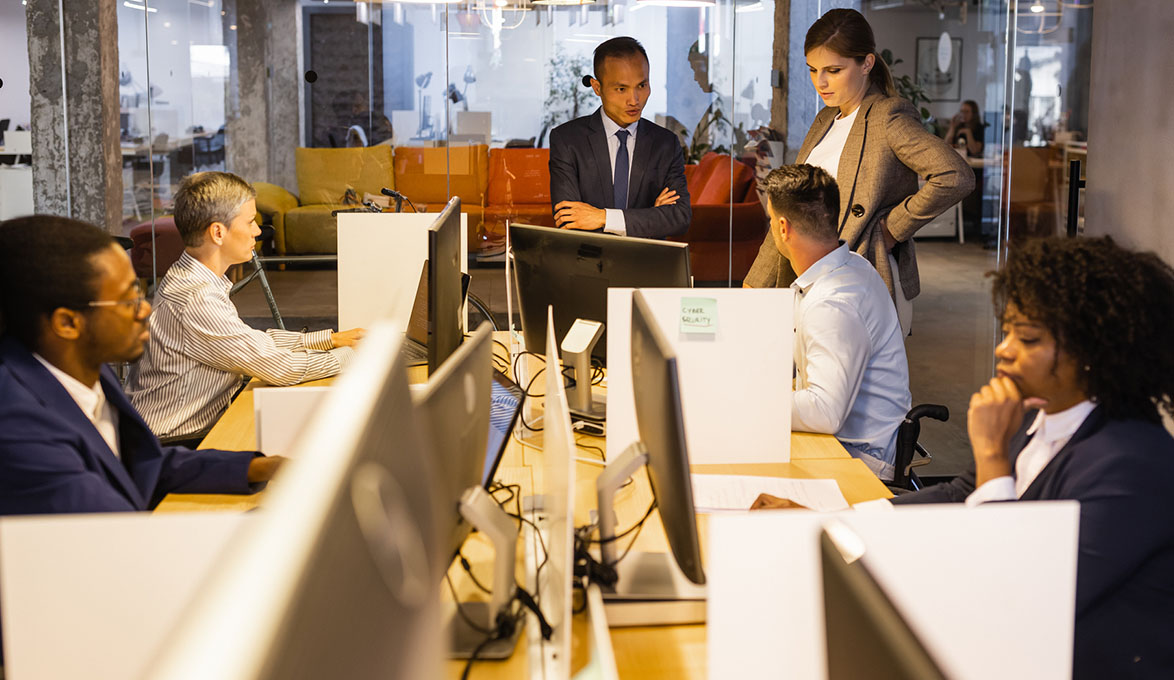 business owner talking to employees about fraud threats