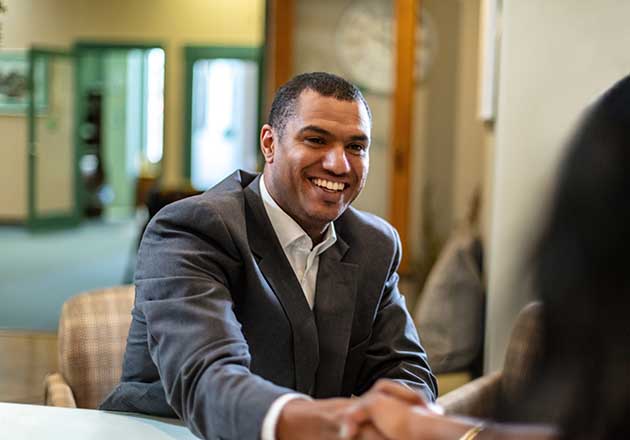 A man works with a not-for-profit banker to receive a working capital line of credit