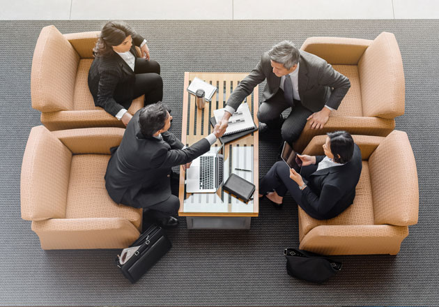 Business people shaking hands and closing a deal