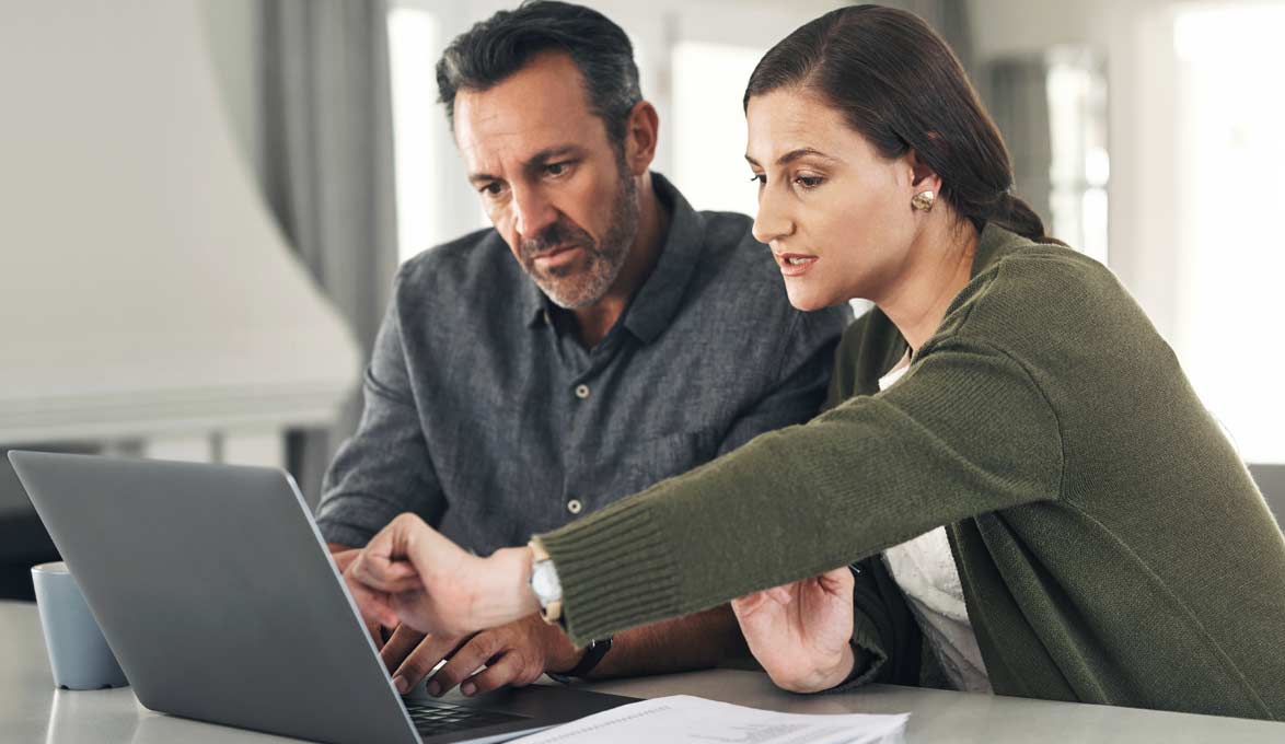Couple using laptop to plan 401K