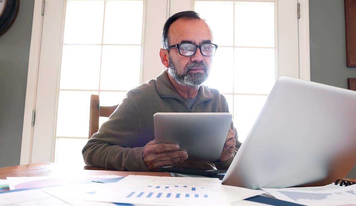 man looking at portfolio risk