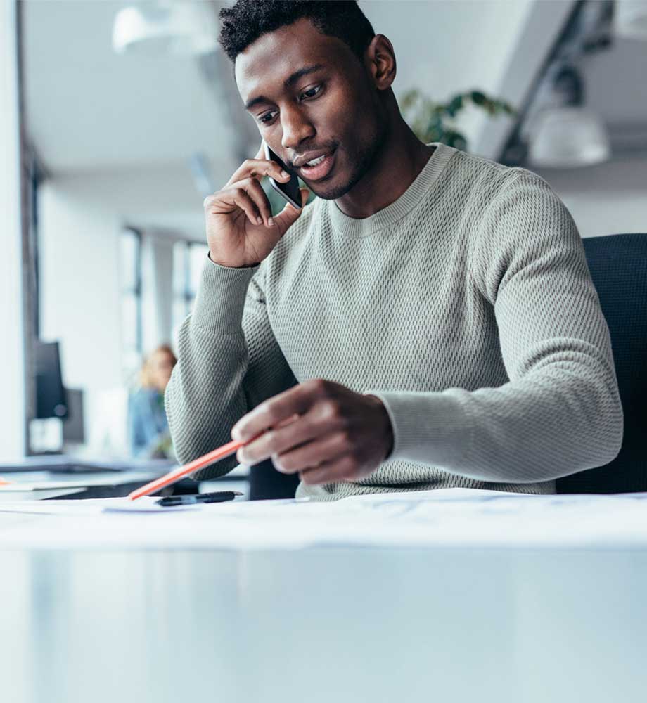 A man at a desk, working on his investment portfolio