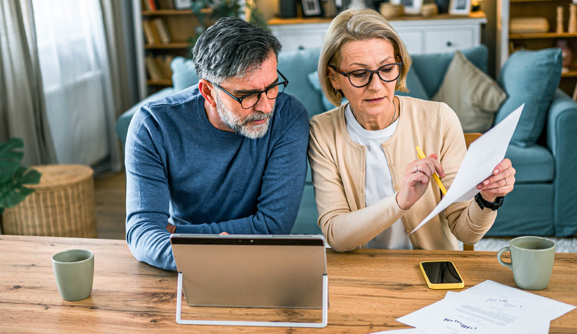 A middle-aged couple planning their investment portfolio