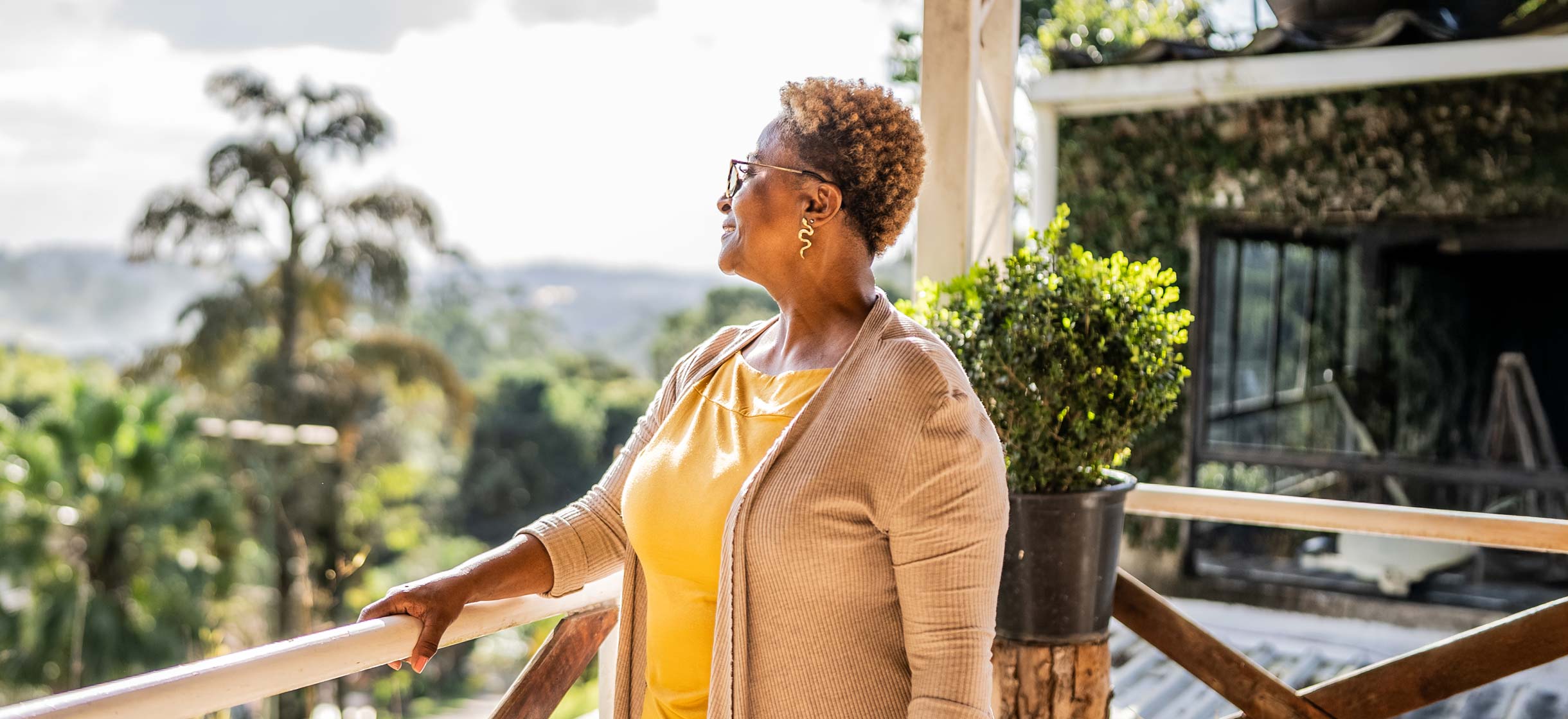 An older woman standing on a balcony