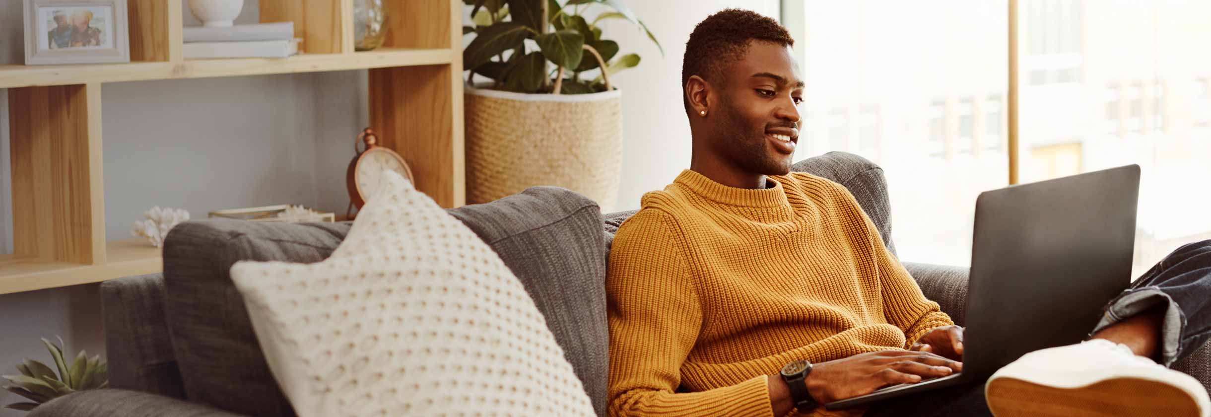 Man using laptop on the couch