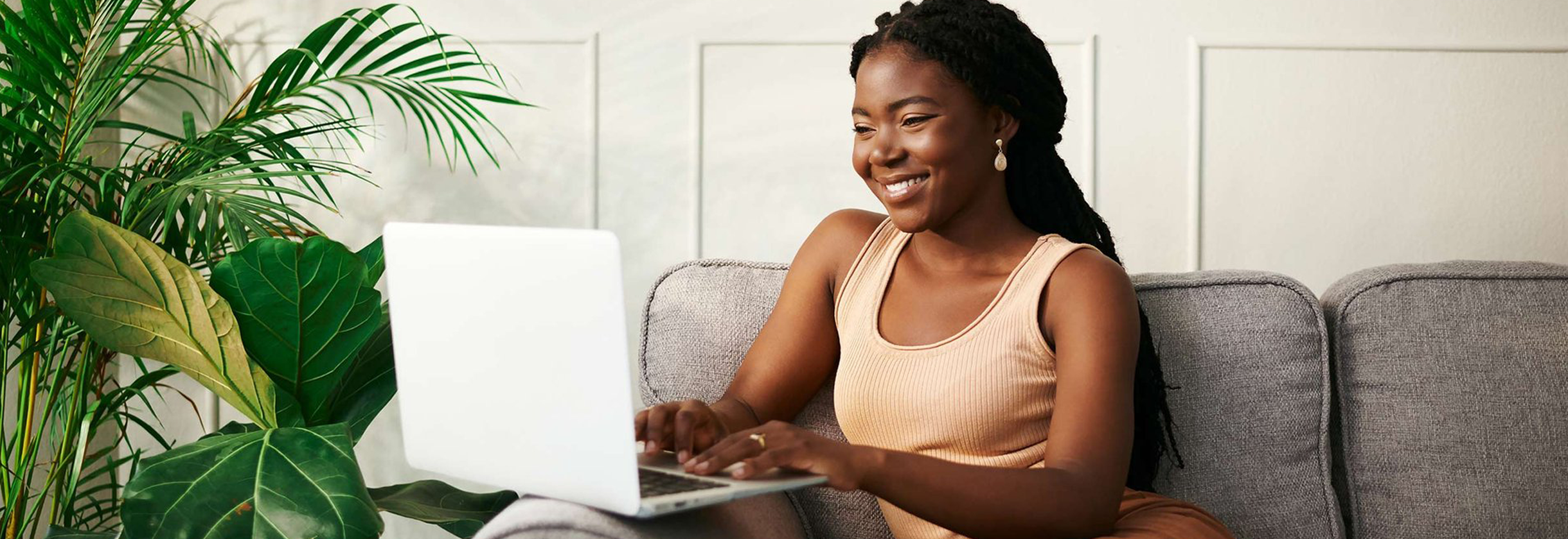 Woman on laptop at home dressed comfortably