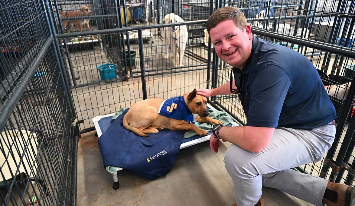 SouthState employee with Final Victory Animal Rescue dog wearing logo bandana
