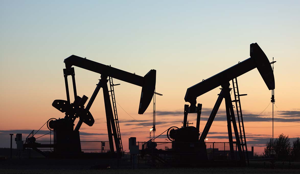 Industrial equipment against a sunset backdrop