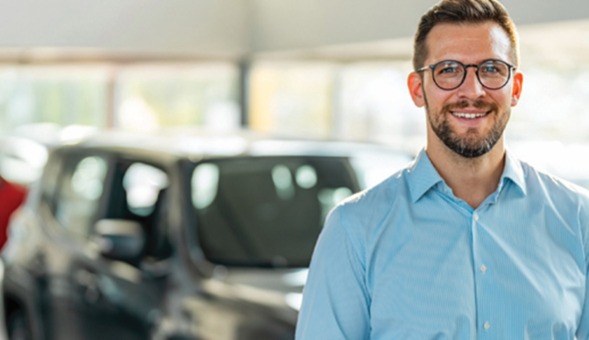 man considering financial impact of buying or leasing vehicle